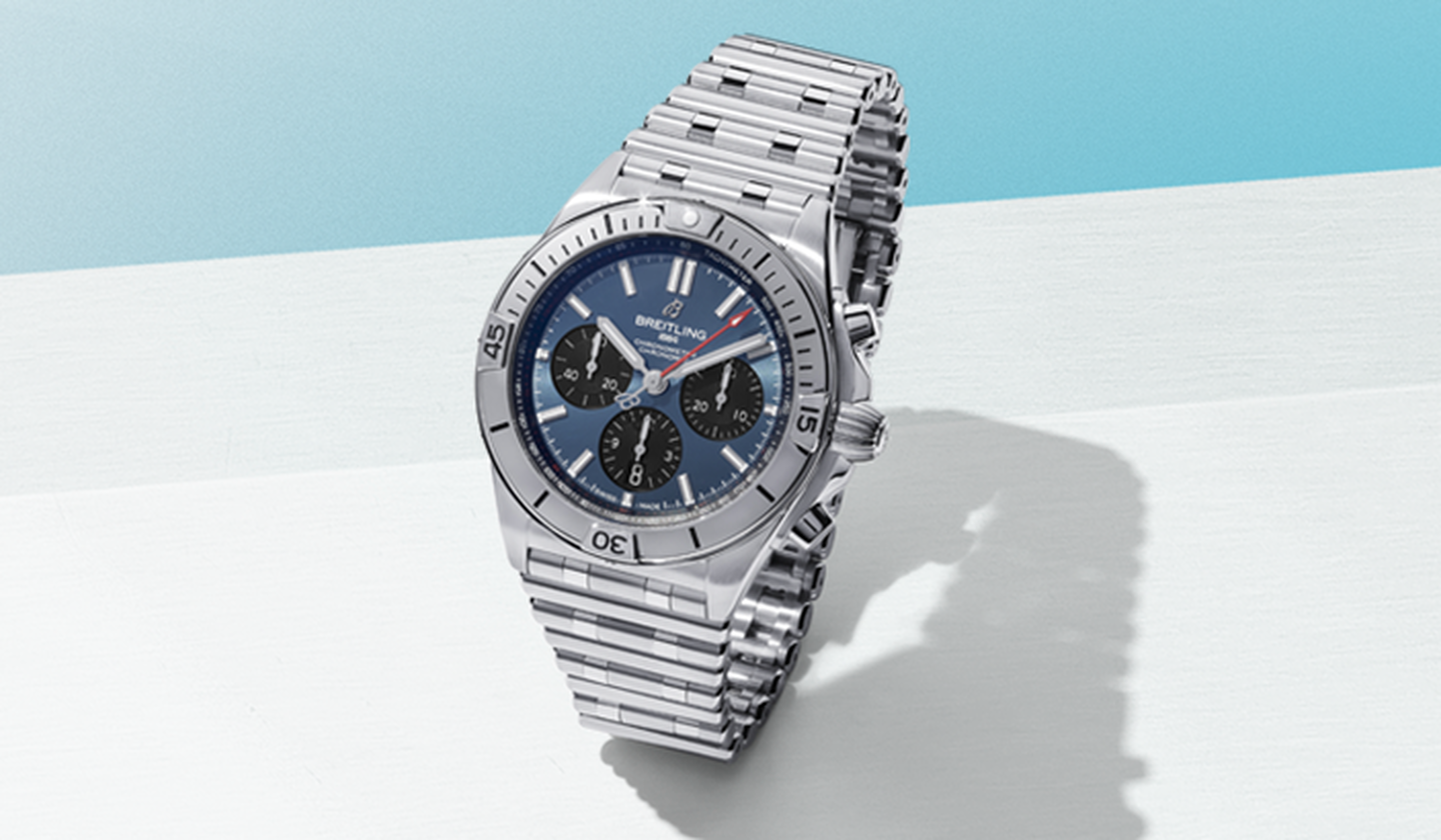 Breitling watch on a light blue background.